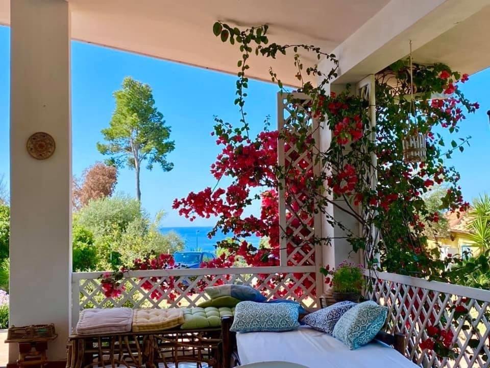 a balcony with flowers and a view of the ocean at Villa Mare Tra Cielo e Mare in Gaeta