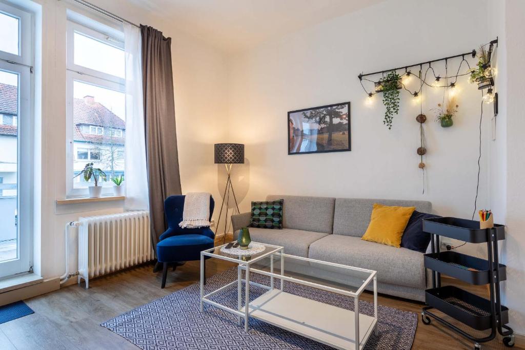 a living room with a couch and a chair at Apartment 54 - Ferienwohnung Bad Arolsen in Bad Arolsen
