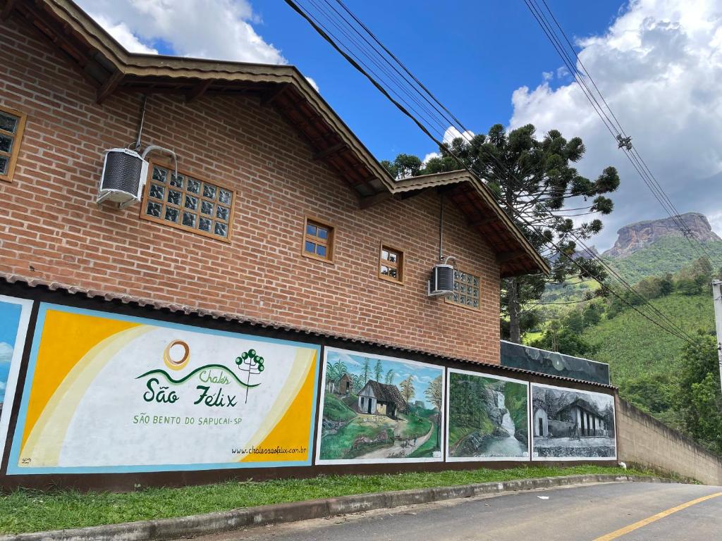 a building with posters on the side of it at Chales Sao Felix in Paiol Grande