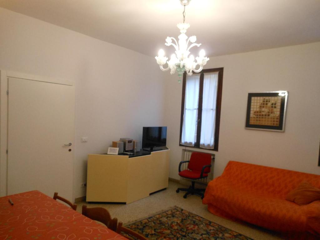 a bedroom with a bed and a chandelier at Appartamenti del Dose in Venice