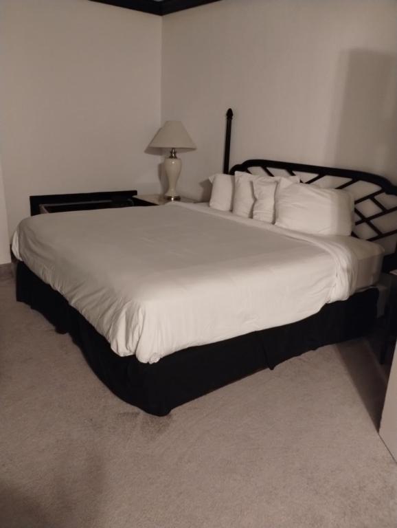 a bedroom with a large bed with white pillows at Bay Valley Resort in Bay City