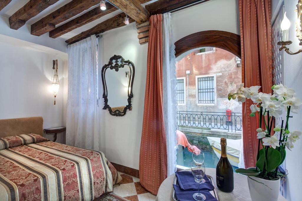 een slaapkamer met een bed en een raam bij Nice Venice Apartments in San Marco in Venetië