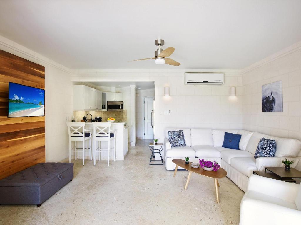 a living room with a white couch and a table at ZenBreak Westmoreland Sago 113 in Saint James