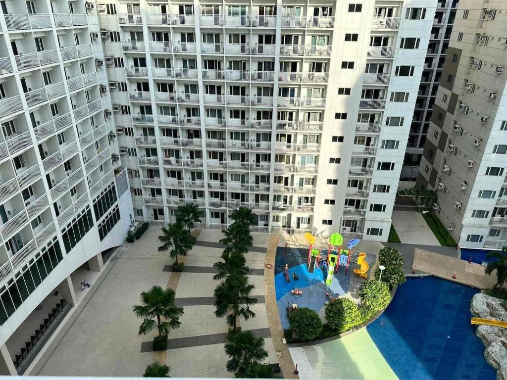an aerial view of a apartment complex with a water park at Shawnalyn Condo-tel at Mall of Asia Philippines in Manila