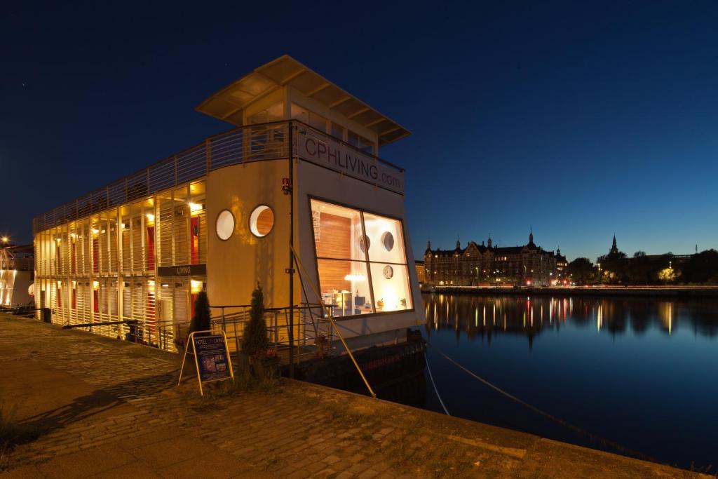 a building next to a body of water at night at Hotel CPH Living in Copenhagen