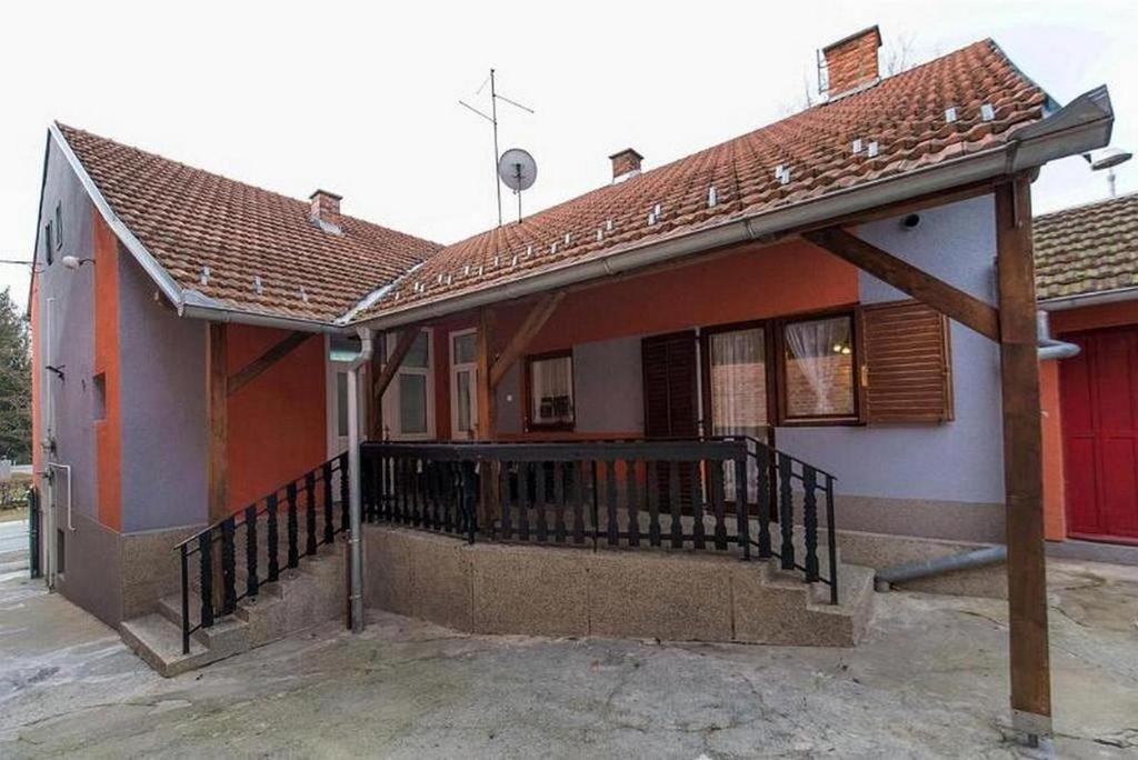 a house with a porch and a balcony at Holiday house with a parking space Daruvar, Bjelovarska - 17937 in Daruvar