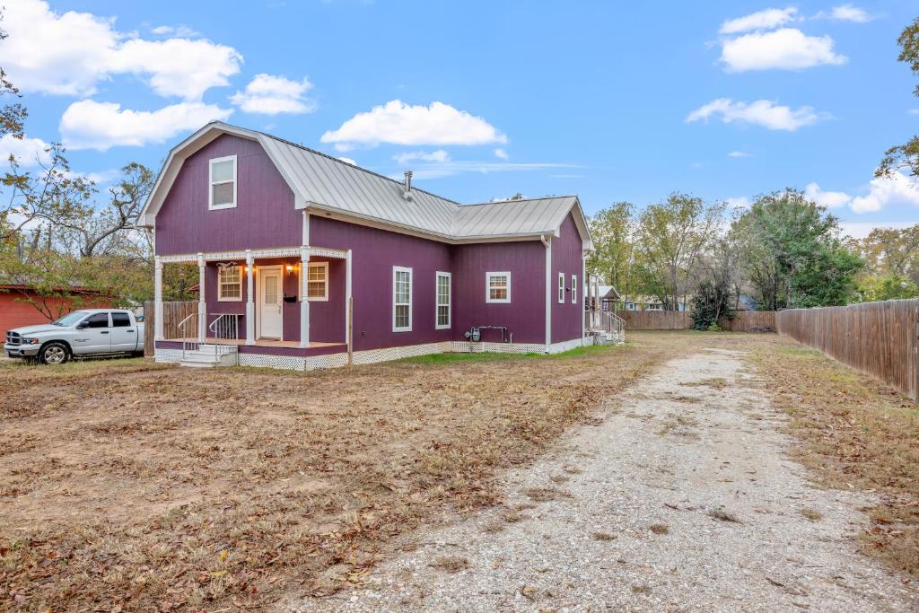 a purple house on a dirt road at MeMes Purple Barn in Fredericksburg