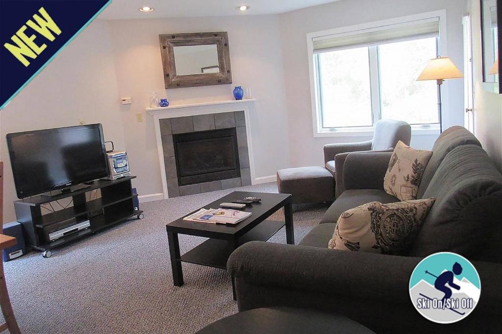 a living room with a couch and a tv at Beautifully decorated 3 bedroom condo nestled Slopeside on Pico Mountain Ski-in Ski-out G101 in Killington