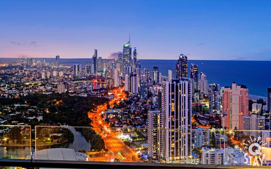 a view of a large city at night at Casino Private Apartments - QStay in Gold Coast
