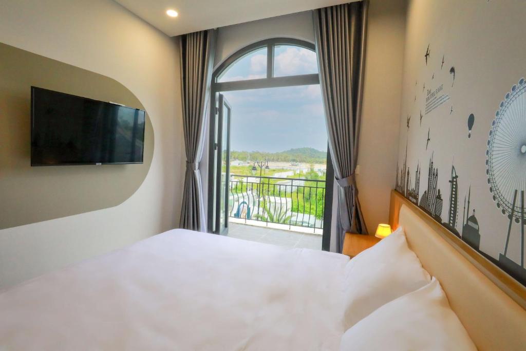 a hotel room with a bed and a window at The Sol House in Phu Quoc