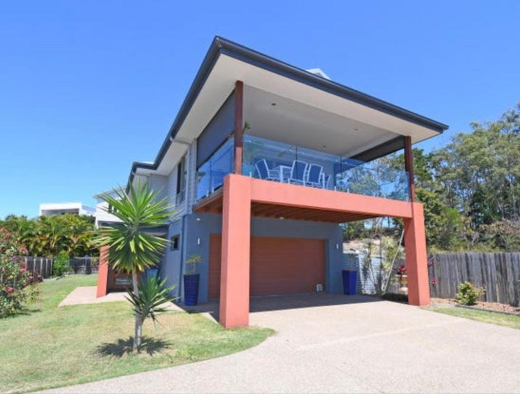 a large house with a garage in front of it at Two Storey Beach House in Hervey Bay