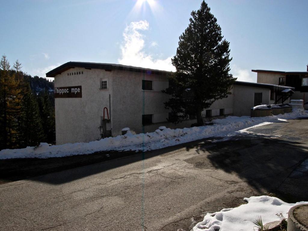a building with snow on the side of a road at Studio Chamrousse, 1 pièce, 3 personnes - FR-1-340-264 in Chamrousse