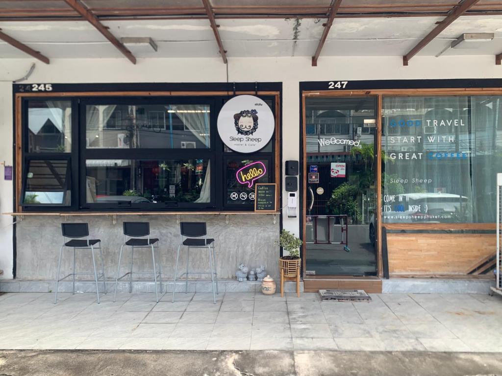 a bar with stools in front of a restaurant at Sleep Sheep Phuket Hostel SHA in Phuket Town
