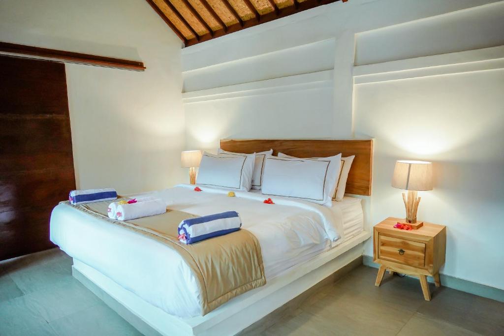 Postel nebo postele na pokoji v ubytování Marygio Gili Resort