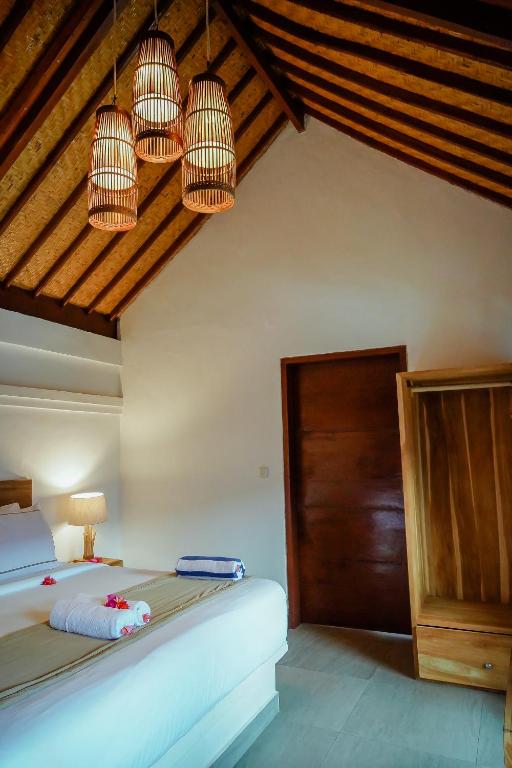 Postel nebo postele na pokoji v ubytování Marygio Gili Resort