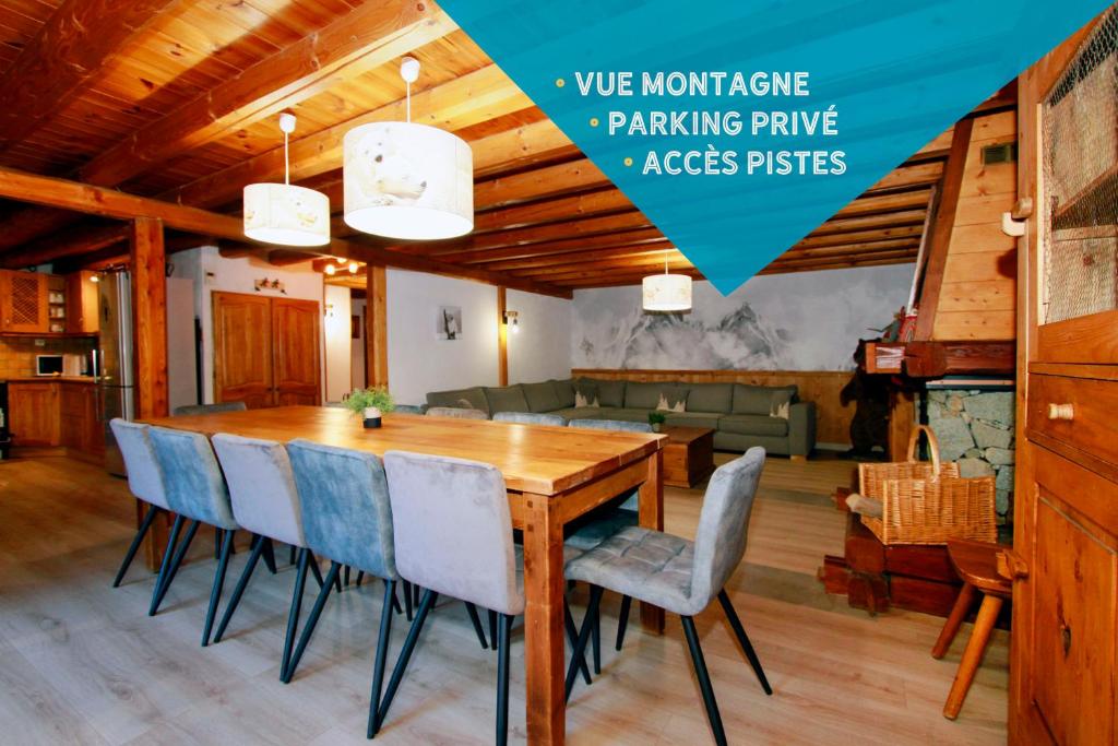 a dining room with a wooden table and chairs at 2AlpesChalets - Chalet Marie 1 - Standing et Sauna aux pieds des pistes in Les Deux Alpes