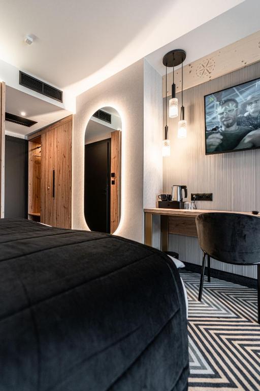 Televízia a/alebo spoločenská miestnosť v ubytovaní Aparthotel Zakopane