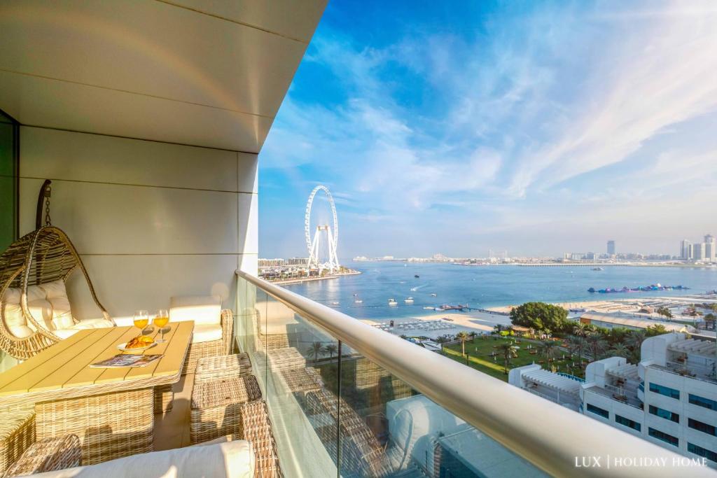 a view of the ocean from the balcony of a hotel at LUX - The JBR Dubai Eye Suite in Dubai