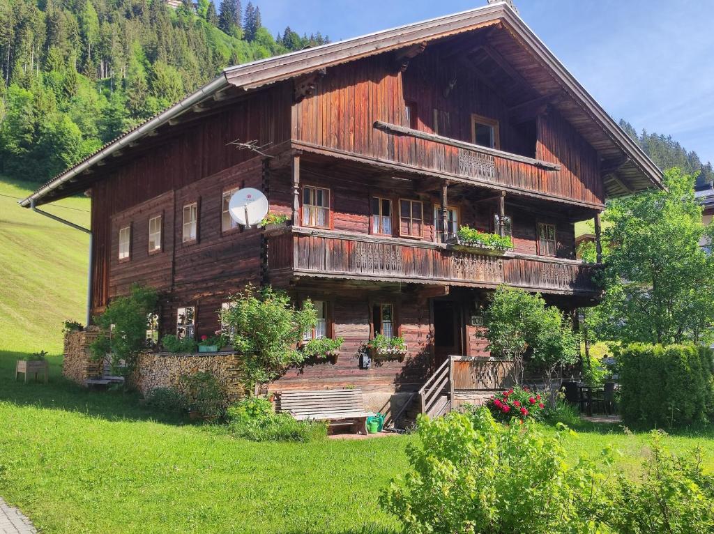 a large wooden house in a green field at Loya Chalet WILD32 in Oberau