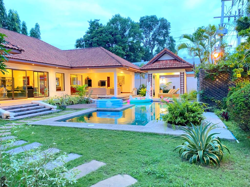 a house with a swimming pool in the yard at Sunny1 villa Pattaya in Ban Huai Yai