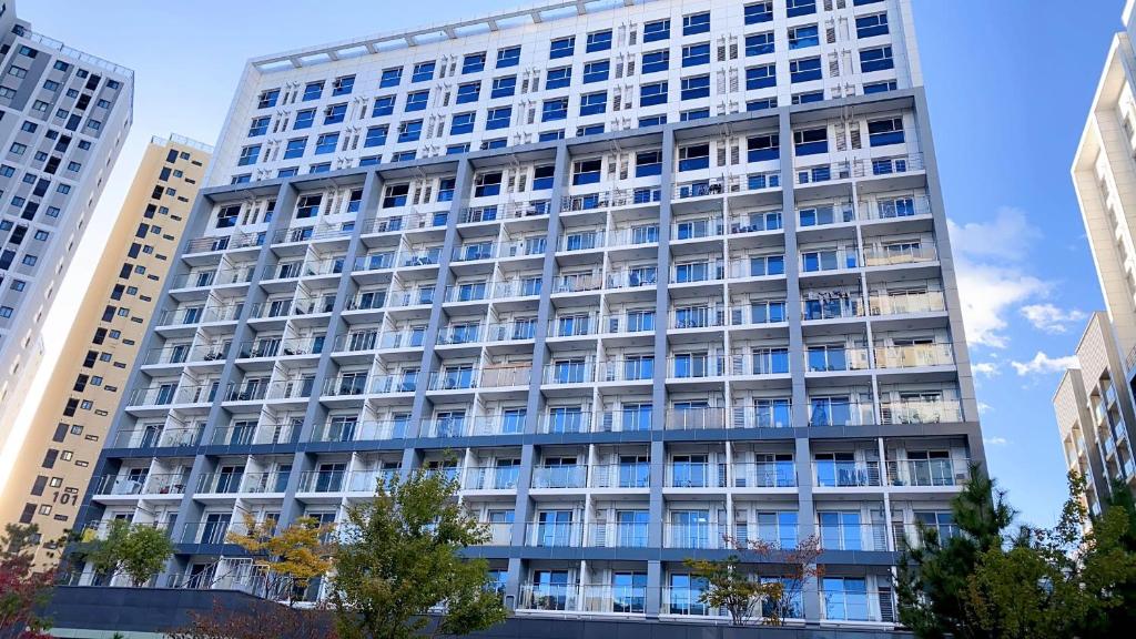 a tall building with blue windows in a city at Central City in Incheon