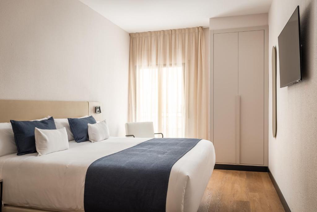 Postel nebo postele na pokoji v ubytování Hotel Don Jaime 54