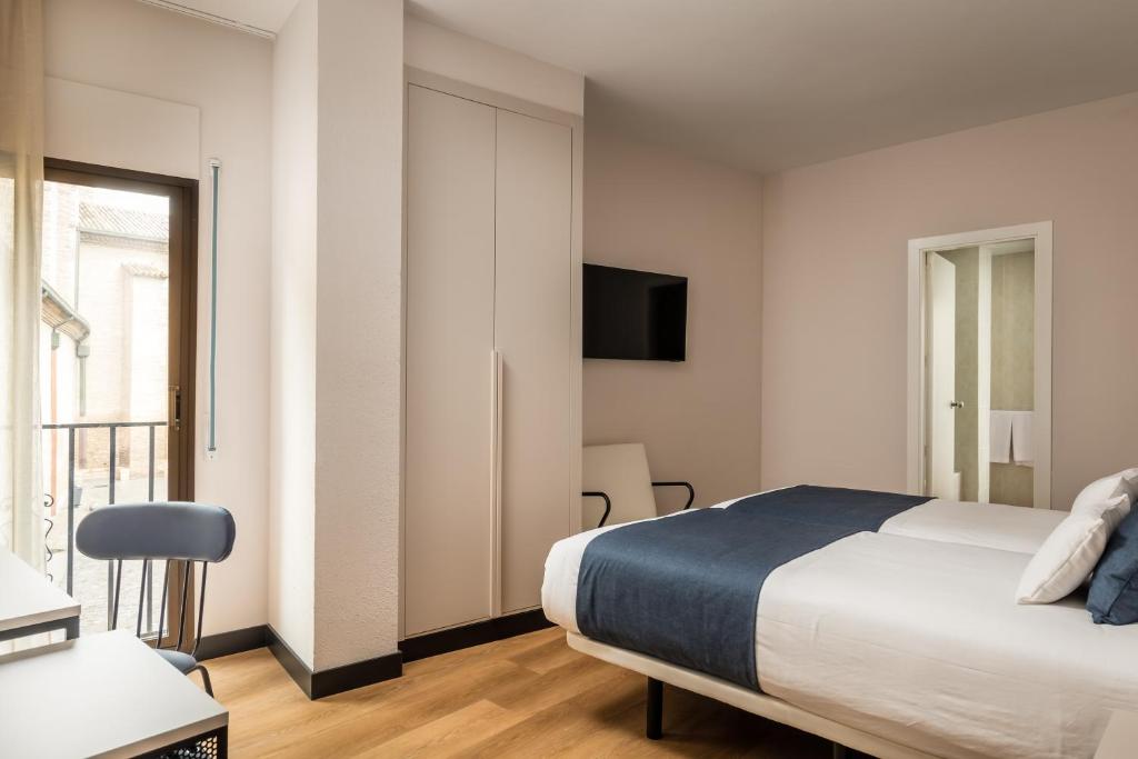Postel nebo postele na pokoji v ubytování Hotel Don Jaime 54