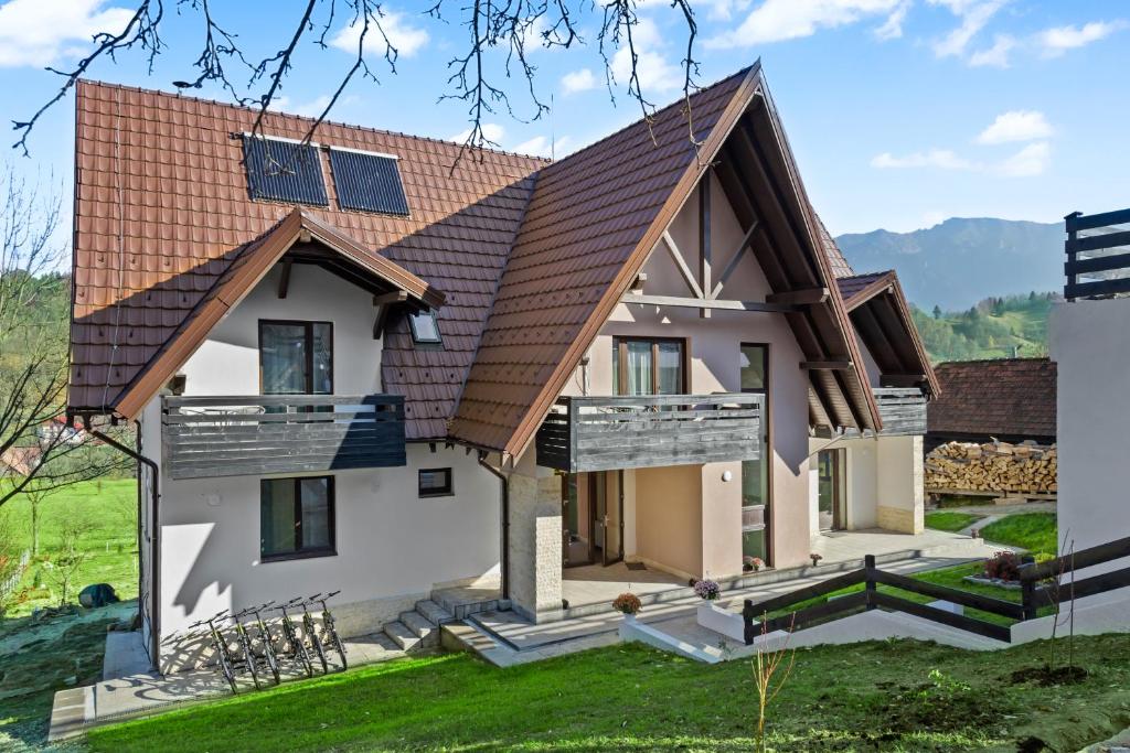 a house with solar panels on the roof at Pensiunea Podul Simonului in Bran