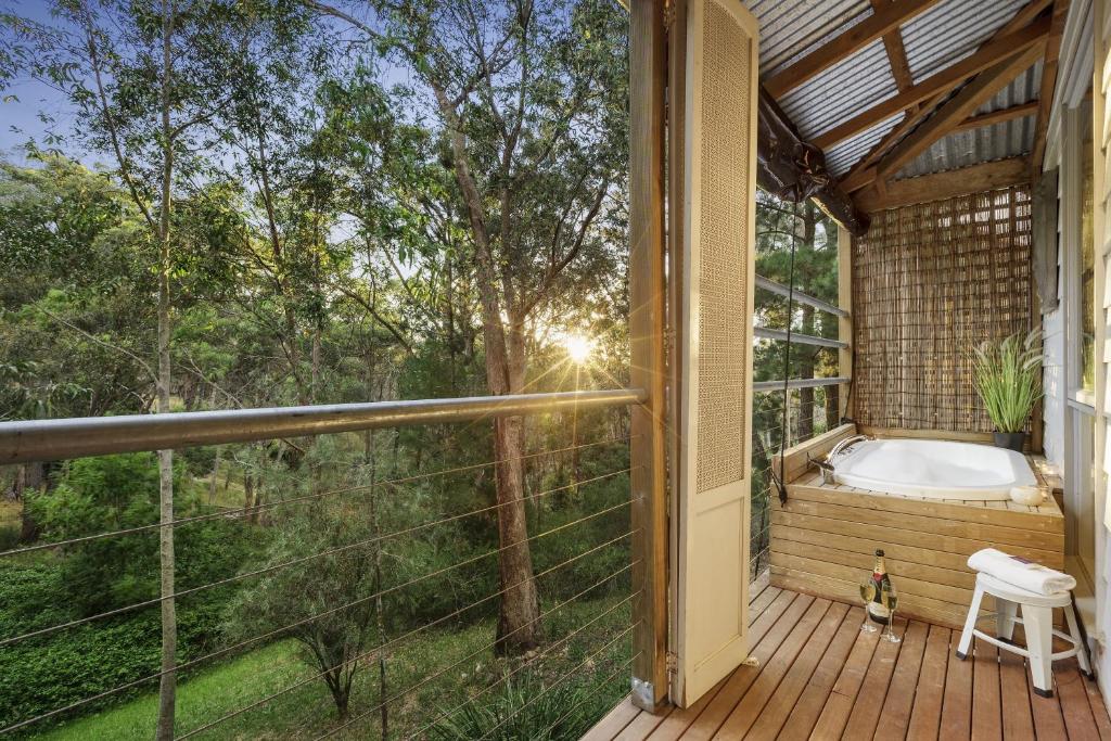 a screened in porch with a tub on a deck at Briars Cottage - Daylesford in Daylesford