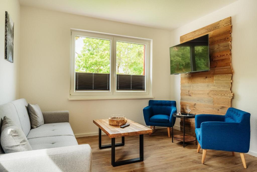 a living room with a couch and chairs and a table at Reitstieg in Braunlage