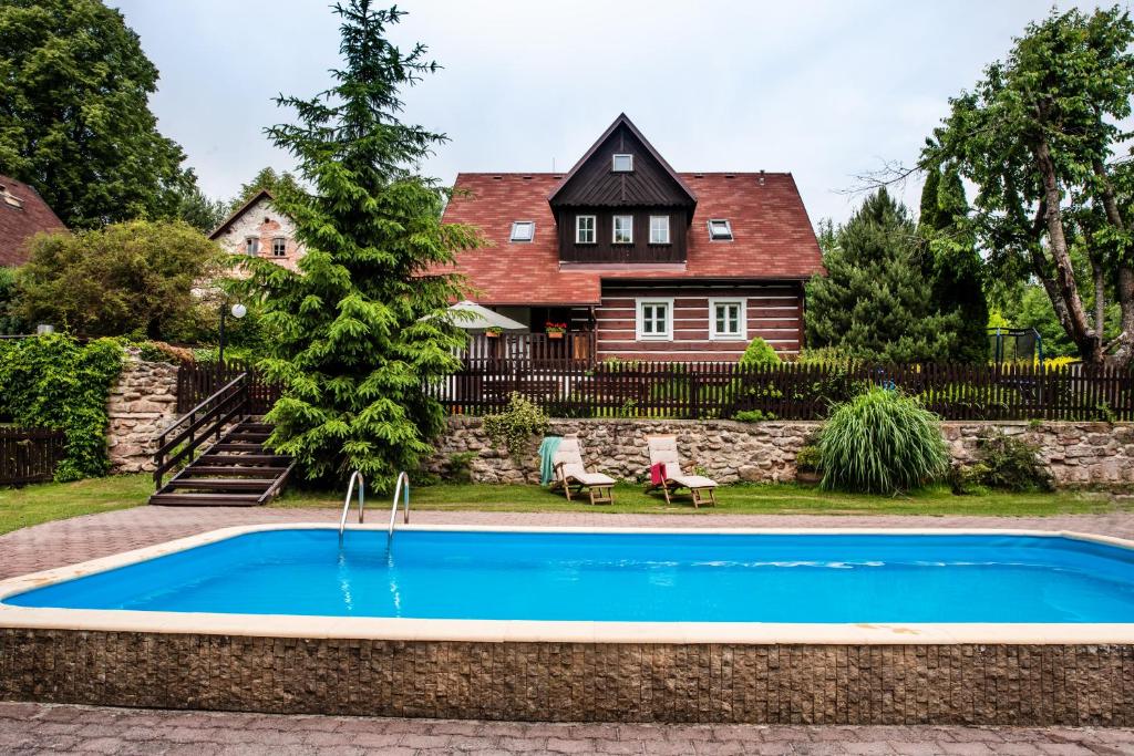 a swimming pool in front of a house at Chalupa nad Popelkou in Lomnice nad Popelkou