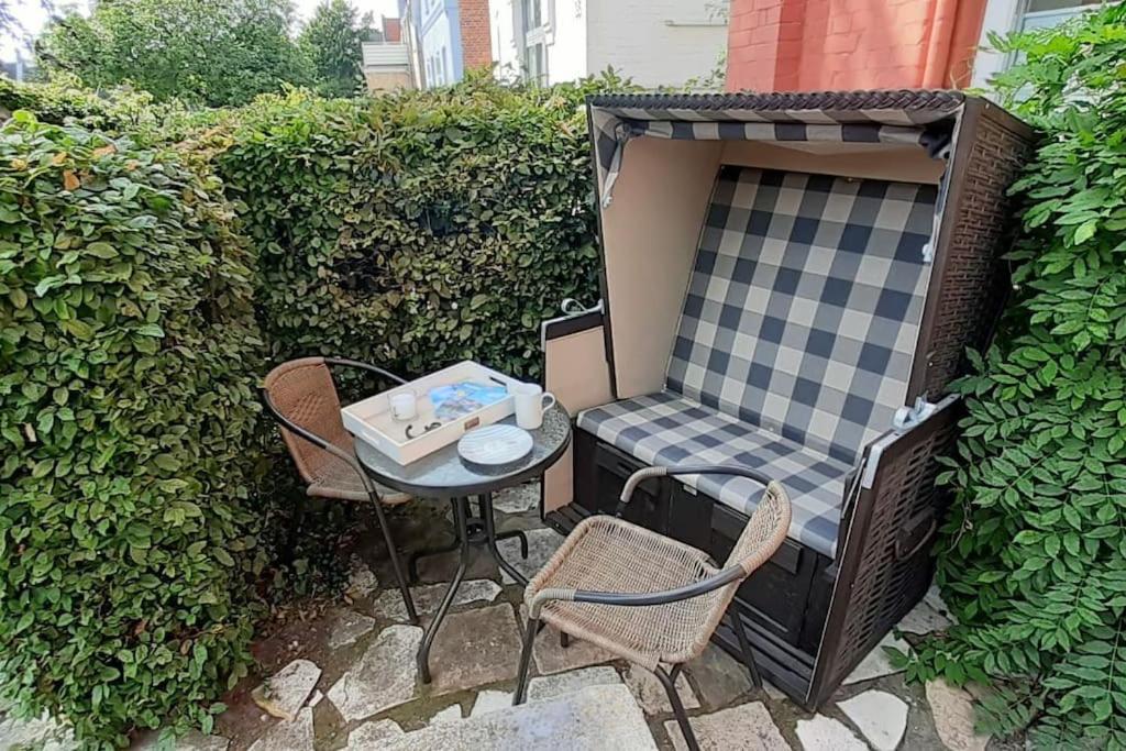 a small table and chairs sitting on a patio at Ahoi Husum, anlegen und wohlfühlen in Husum