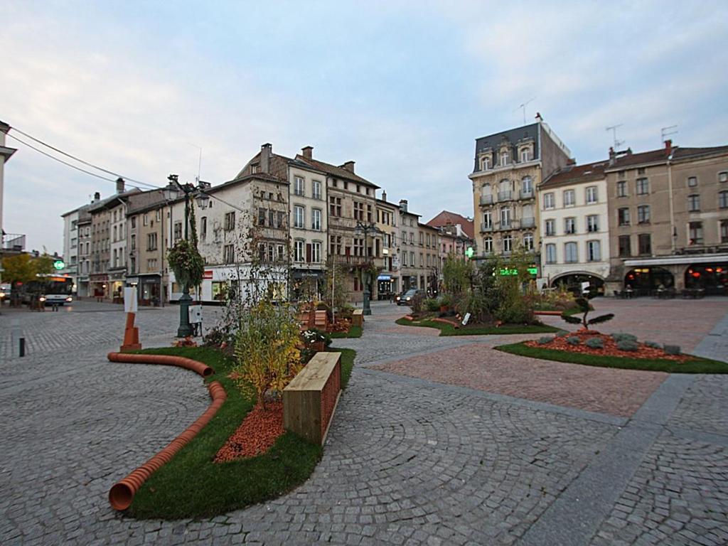 a city street with buildings and a park with trees at Gîte Épinal, 4 pièces, 6 personnes - FR-1-589-82 in Épinal