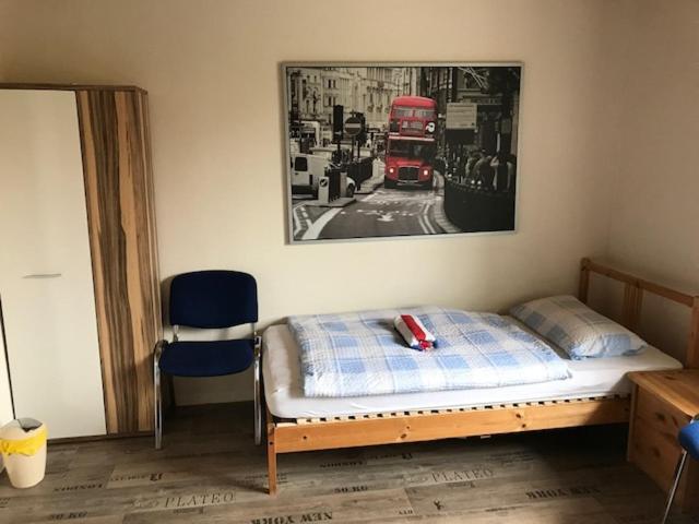 a bedroom with a bed and a red double decker bus at Clarkes Apartments in Leopoldshöhe