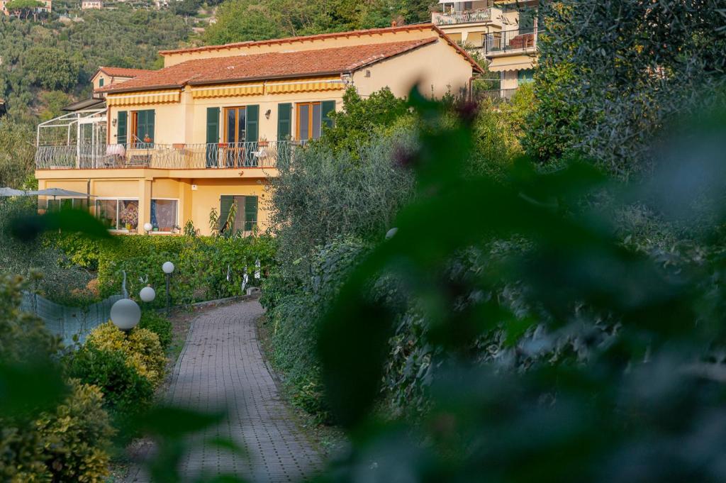 a large yellow house with a walkway in front of it at LA CASA DEI NONNI in Lerici