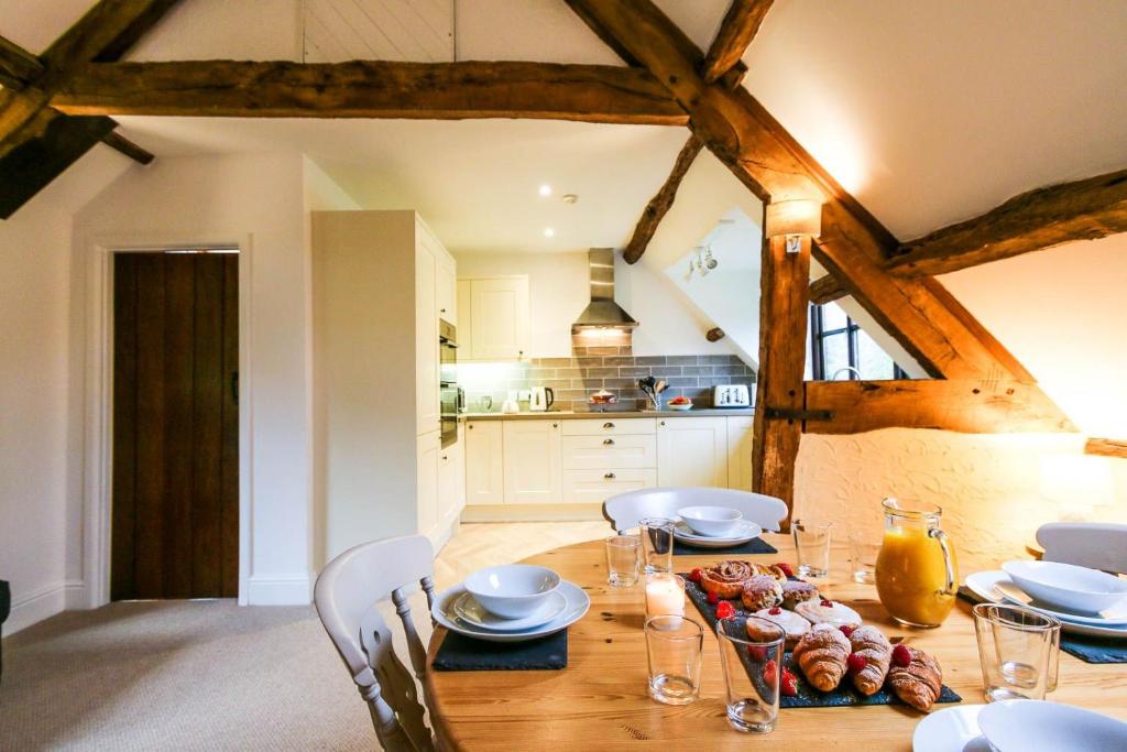 a dining room table with plates and dishes on it at Kestrel Cottage in Builth Wells