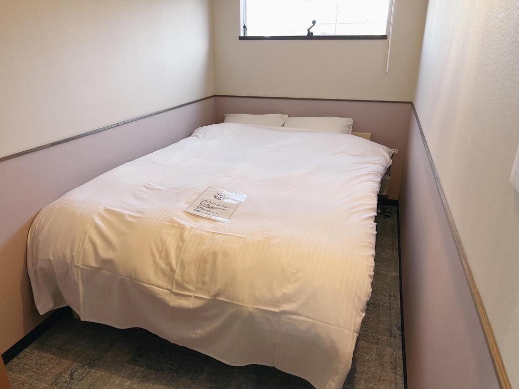 Postel nebo postele na pokoji v ubytování KIIIYA cafe&hostel