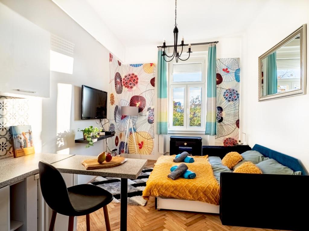 a living room with a bed and a table at Gogol Studio Apartment in Budapest