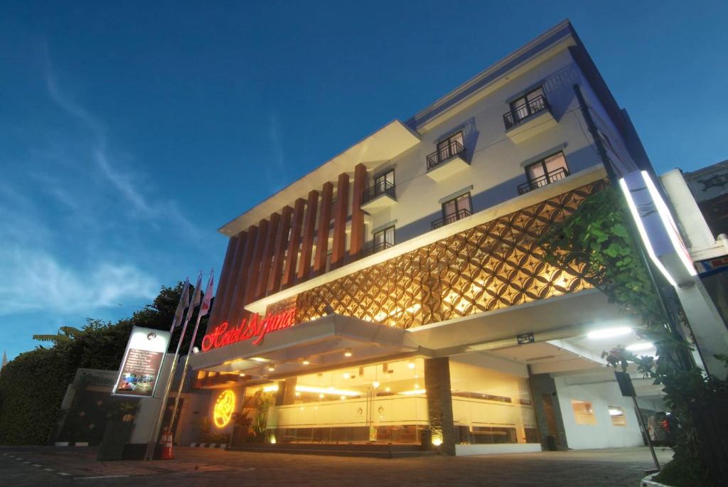 a building with a sign on the side of it at Hotel Arjuna in Yogyakarta