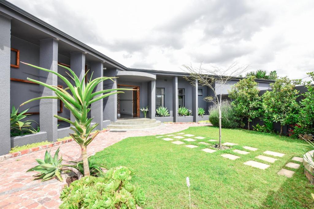 an exterior view of a house with a yard at OnQ Accommodation in Bellville