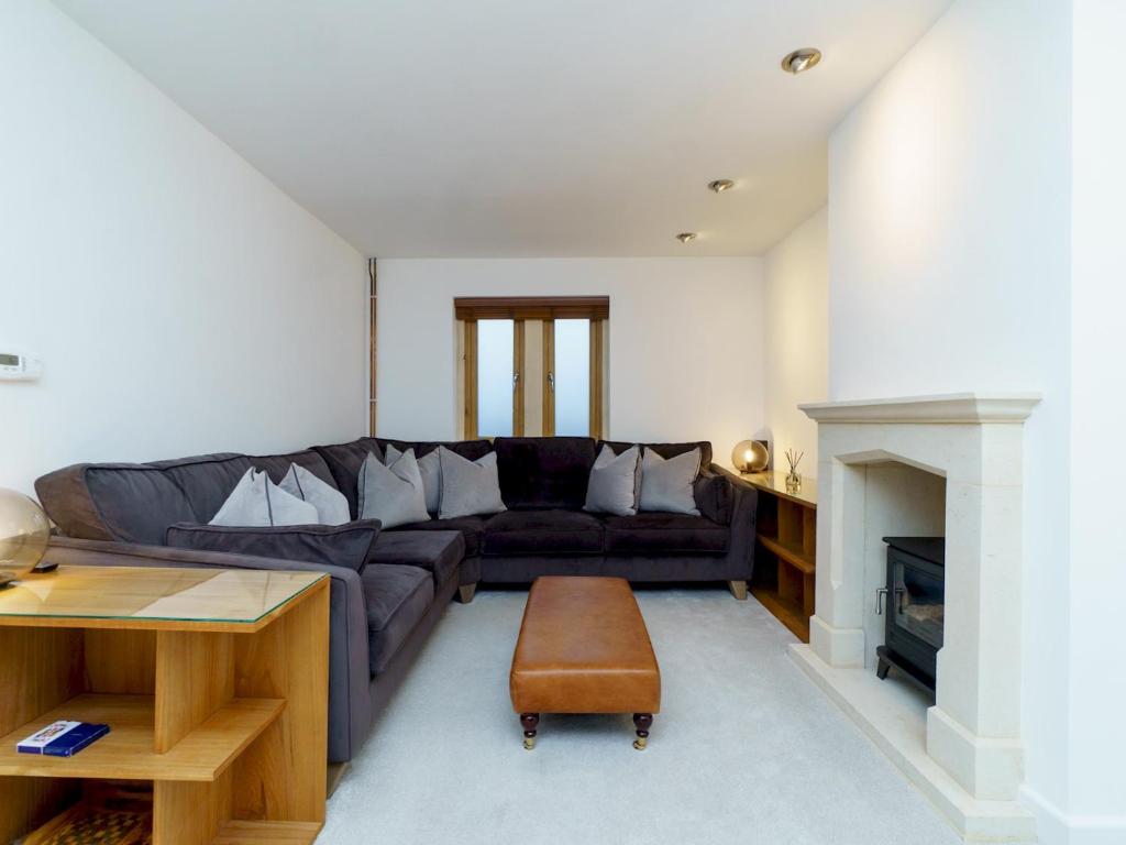 a living room with a couch and a table at Pass the Keys Modern 3 bed home with offstreet parking in Bath