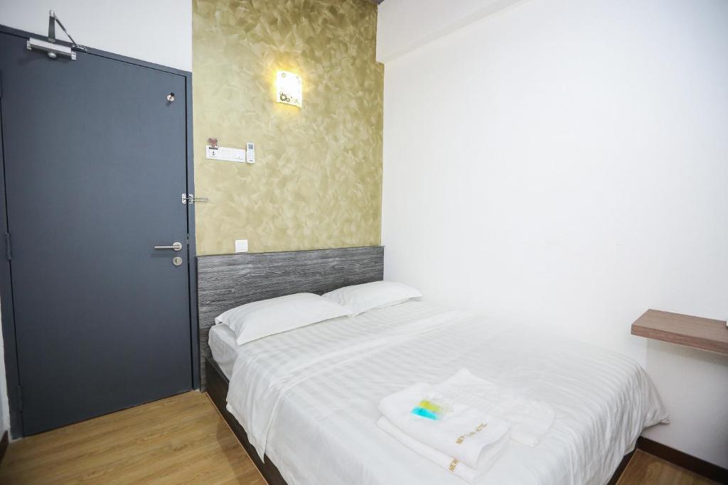 Postel nebo postele na pokoji v ubytování New Dawn Hotel Pontian Sdn Bhd