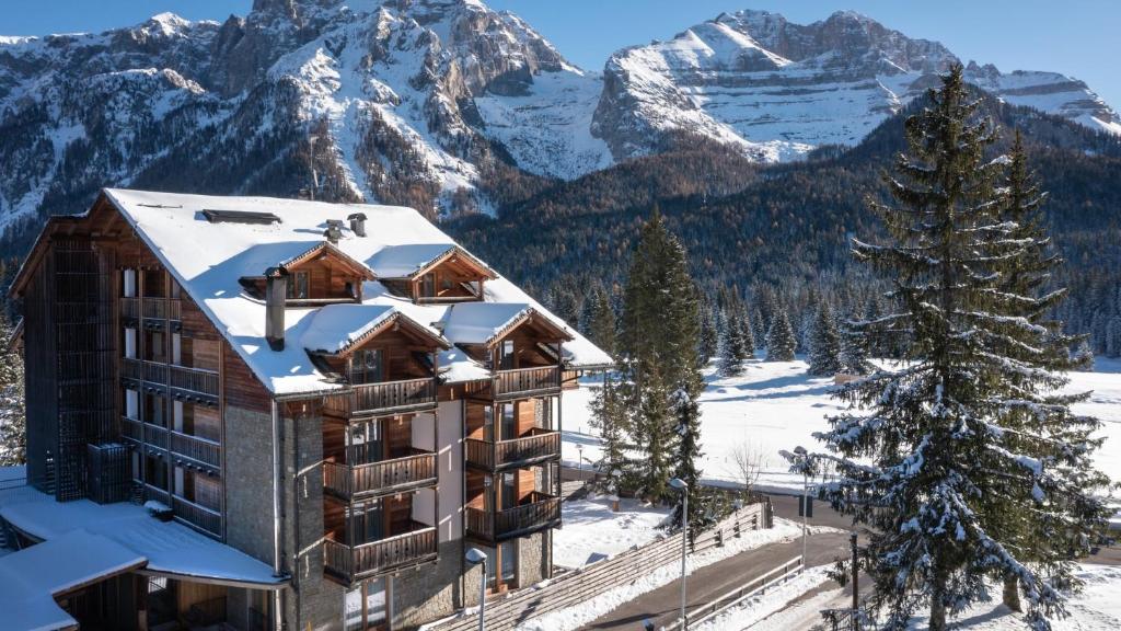 a hotel in the mountains with snow on the roof at Maribel Hotel in Madonna di Campiglio