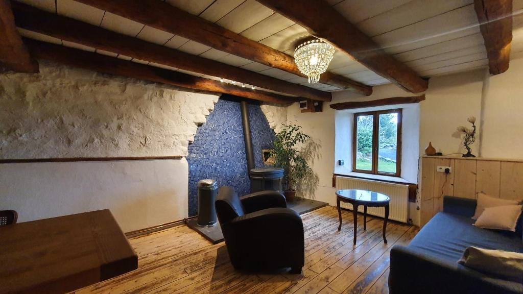 a living room with a couch and a table at La chambre d&#39;hôte du Petit Mazilloux in Présailles