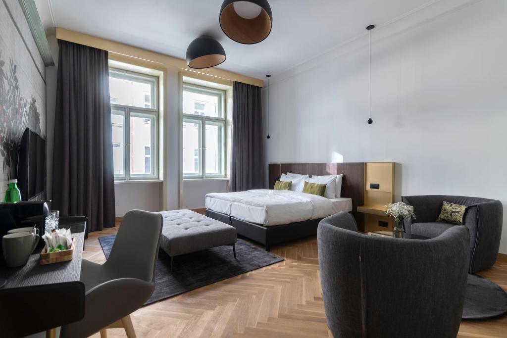 a bedroom with a bed and a living room at numa I Laurel in Prague