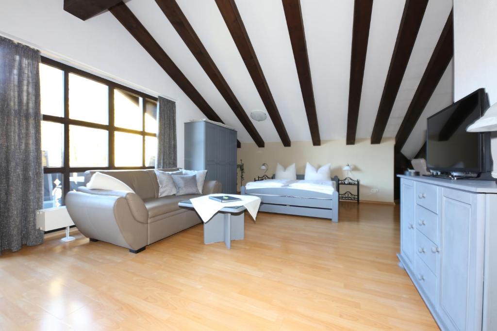 a living room with a couch and a table at Ferienwohnung AlpspitzNest in Garmisch-Partenkirchen