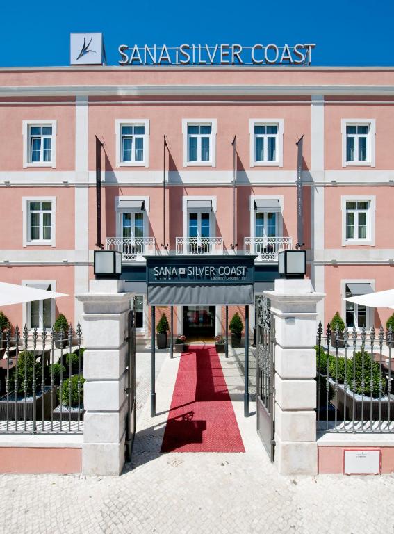a building with a red carpet in front of a building at SANA Silver Coast Hotel in Caldas da Rainha