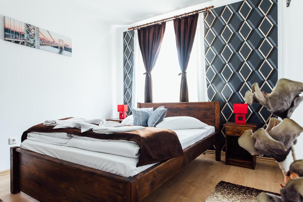 a bedroom with a wooden bed and a window at Guesthouse Viktoria Pensiune in Praid