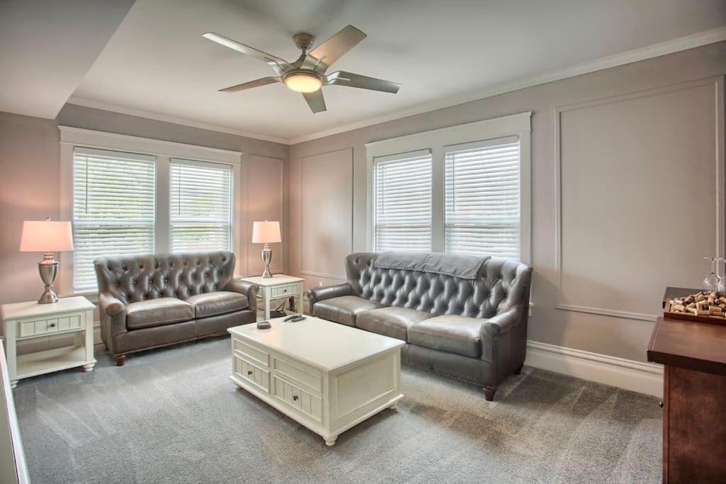 a living room with two couches and a ceiling fan at Suites on Seneca - Beautiful 1 Bedroom Apartment in Harrisburg