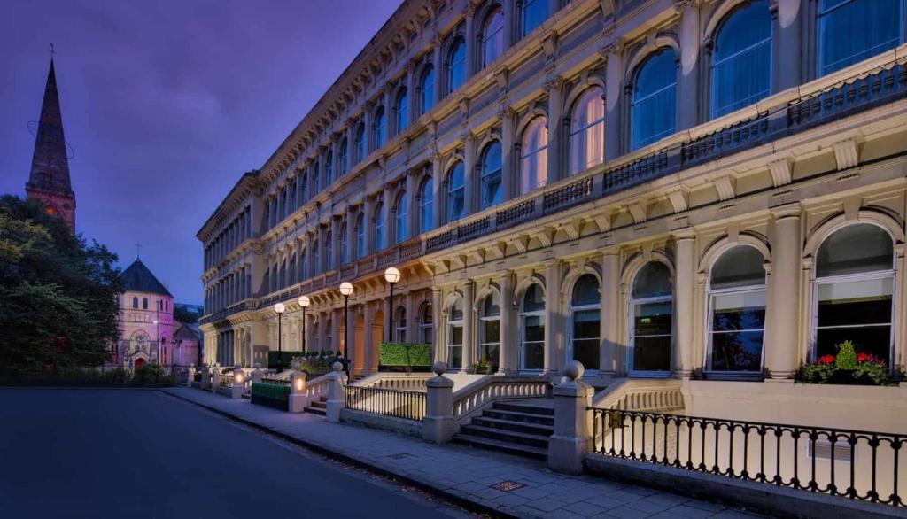 a large building with a staircase in front of it at Glasgow Grosvenor Hotel in Glasgow